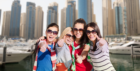 Image showing young women showing thumbs up over city harbour