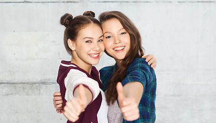 Image showing happy smiling teenage girls showing thumbs up