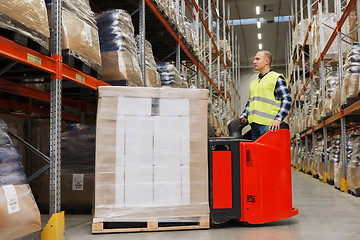 Image showing man on forklift loading cargo at warehouse