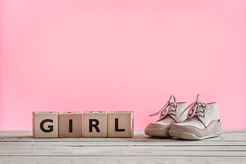 Image showing Baby girl shoes on a table