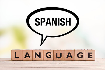 Image showing Spanish language lesson sign on a table