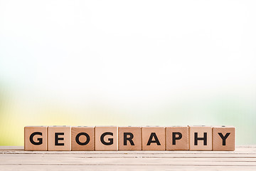 Image showing Geography lesson sign on a wooden desk