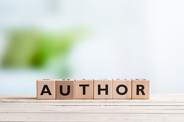 Image showing Author sign on a wooden desk