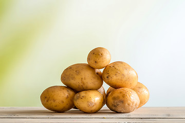 Image showing Potatoes on a wooden table