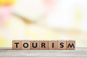 Image showing Tourism sign on a wooden desk