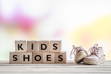 Image showing Kids shoes on a wooden desk