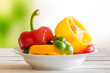 Image showing Plate with pepper fruit on a wooden table