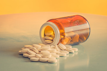 Image showing Pills and a glass on a table