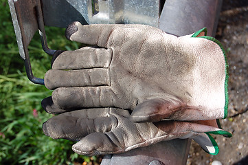 Image showing dirty leather gloves,white