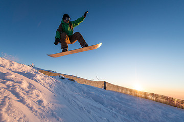 Image showing Snowboarder at jump