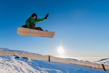 Image showing Snowboarder at jump