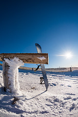 Image showing Snowboard leaning on a wood rail