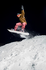 Image showing Snowboarder jumping