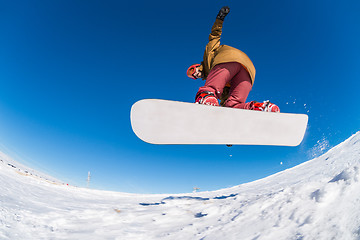 Image showing Snowboarder jumping against blue sky