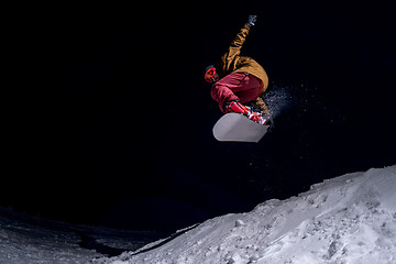 Image showing Snowboarder jumping