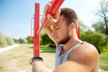 Image showing man with heart-rate watch exercising outdoors