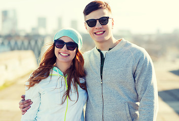 Image showing happy teenage couple walking in city