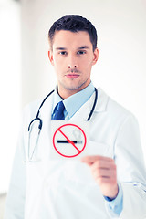 Image showing male doctor holding no smoking sign