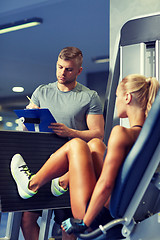 Image showing man and woman flexing muscles on gym machine