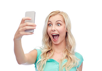 Image showing smiling young woman taking selfie with smartphone