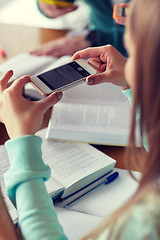 Image showing student hands with smartphone making cheat sheet