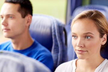 Image showing happy young woman sitting in travel bus or train