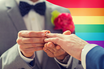 Image showing close up of male gay couple hands and wedding ring