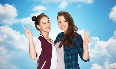 Image showing happy teenage girls hugging and showing peace sign