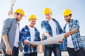 Image showing group of builders with tablet pc and blueprint