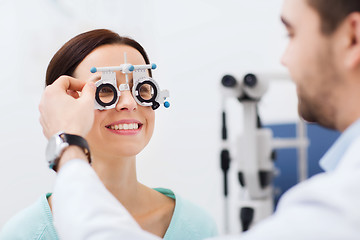 Image showing optician with trial frame and patient at clinic