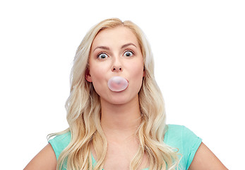 Image showing happy young woman or teenage girl chewing gum