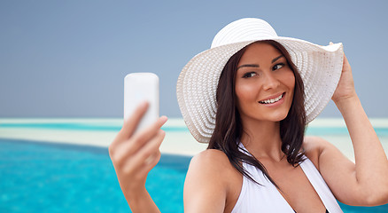 Image showing young woman taking selfie with smartphone