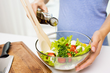 Image showing close up of woman cooking vegetable salad at home