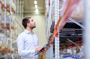 Image showing businessman with clipboard at warehouse