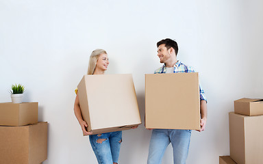 Image showing smiling couple with big boxes moving to new home