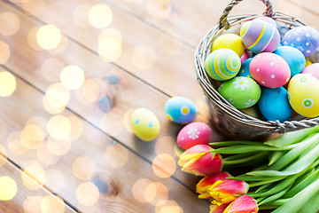 Image showing close up of easter eggs in basket and flowers