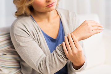 Image showing close up of woman with pain in hand at home