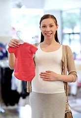 Image showing happy pregnant woman shopping at clothing store