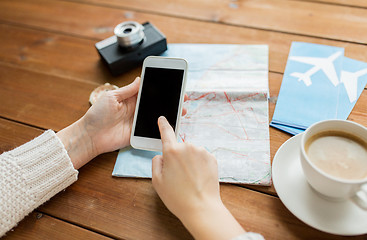 Image showing close up of traveler hands with smartphone and map