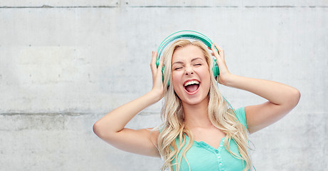 Image showing happy young woman or teenage girl with headphones