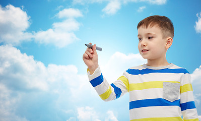 Image showing little boy drawing or writing with marker