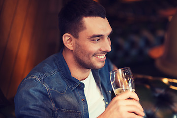 Image showing happy man drinking beer at bar or pub