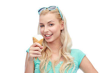 Image showing happy young woman in sunglasses eating ice cream