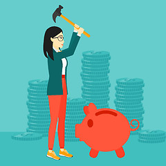 Image showing Woman breaking piggy bank.