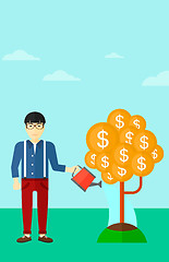 Image showing Man watering money tree.