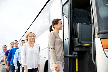 Image showing group of happy passengers boarding travel bus