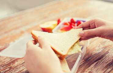 Image showing close up of woman with food in plastic container