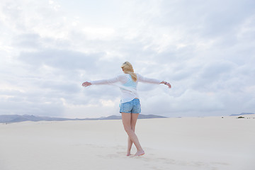 Image showing Carefree woman enjoying freedom on beach.