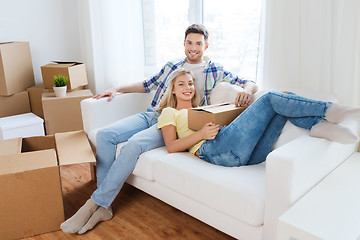 Image showing happy couple with big cardboard boxes at new home
