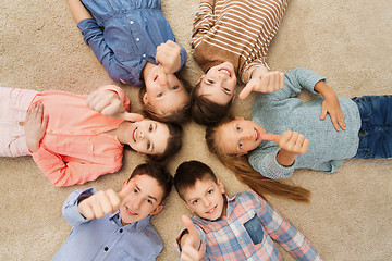 Image showing happy children showing thumbs up on floor